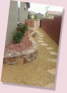 Side yard planter landscaping and rock pathway  by Rising Sun Landscaping & Maintenance